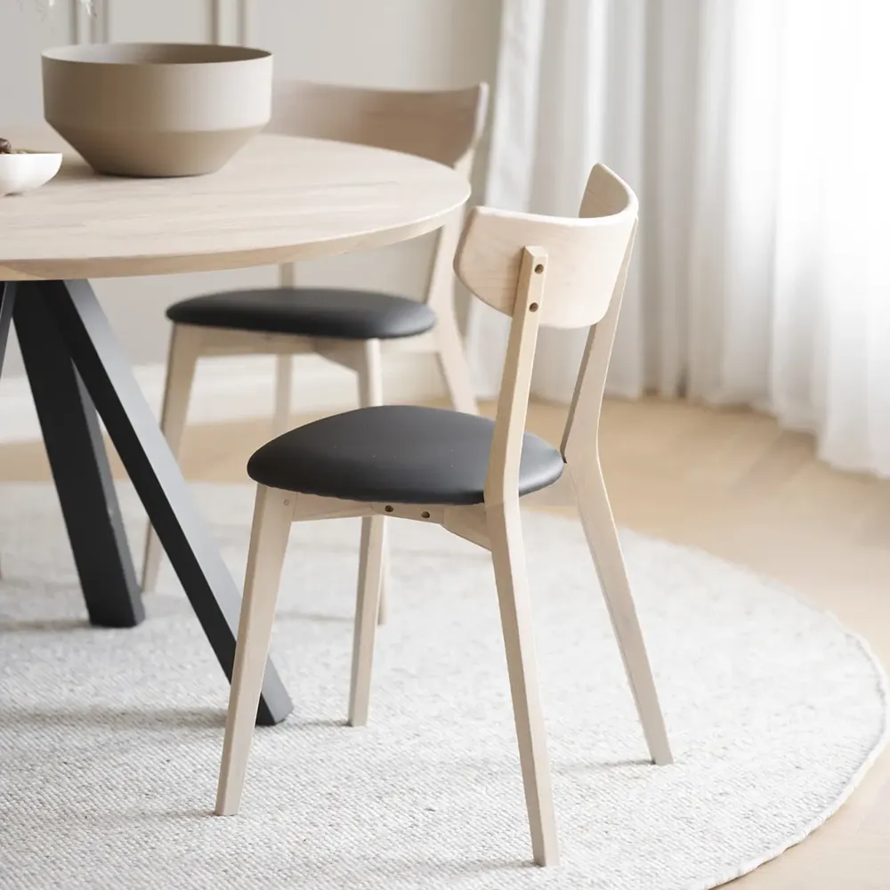 Ami Esszimmerstuhl aus weiß pigmentierter Eiche/schwarzem Kunstleder